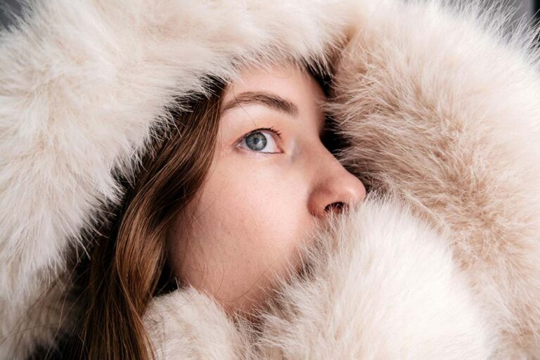woman in a fluffy fur hood looking up